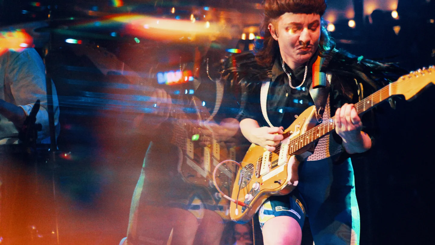 A photo of a musician playing a guitar