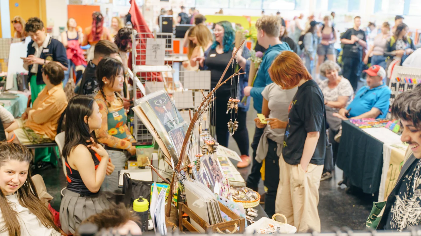 A photo from above of people milling around busy market stalls.