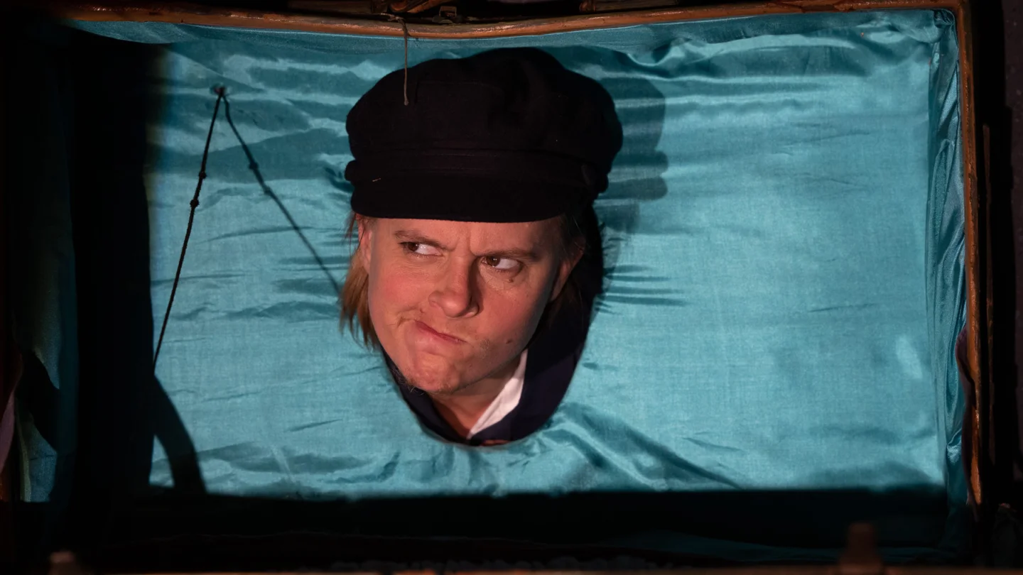 A person is looking through a hole in a sheet