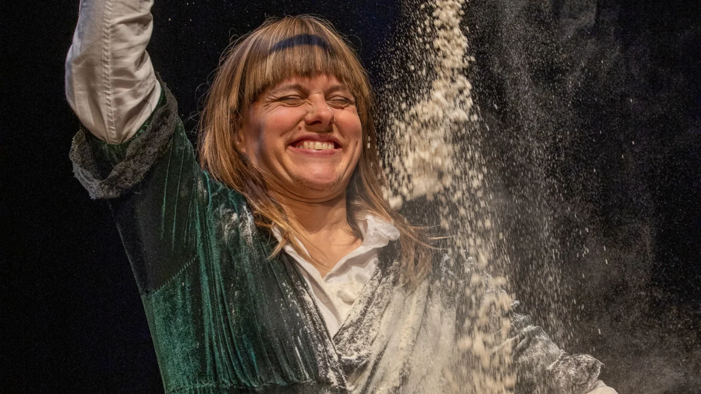 A person pouring flour into a bowl