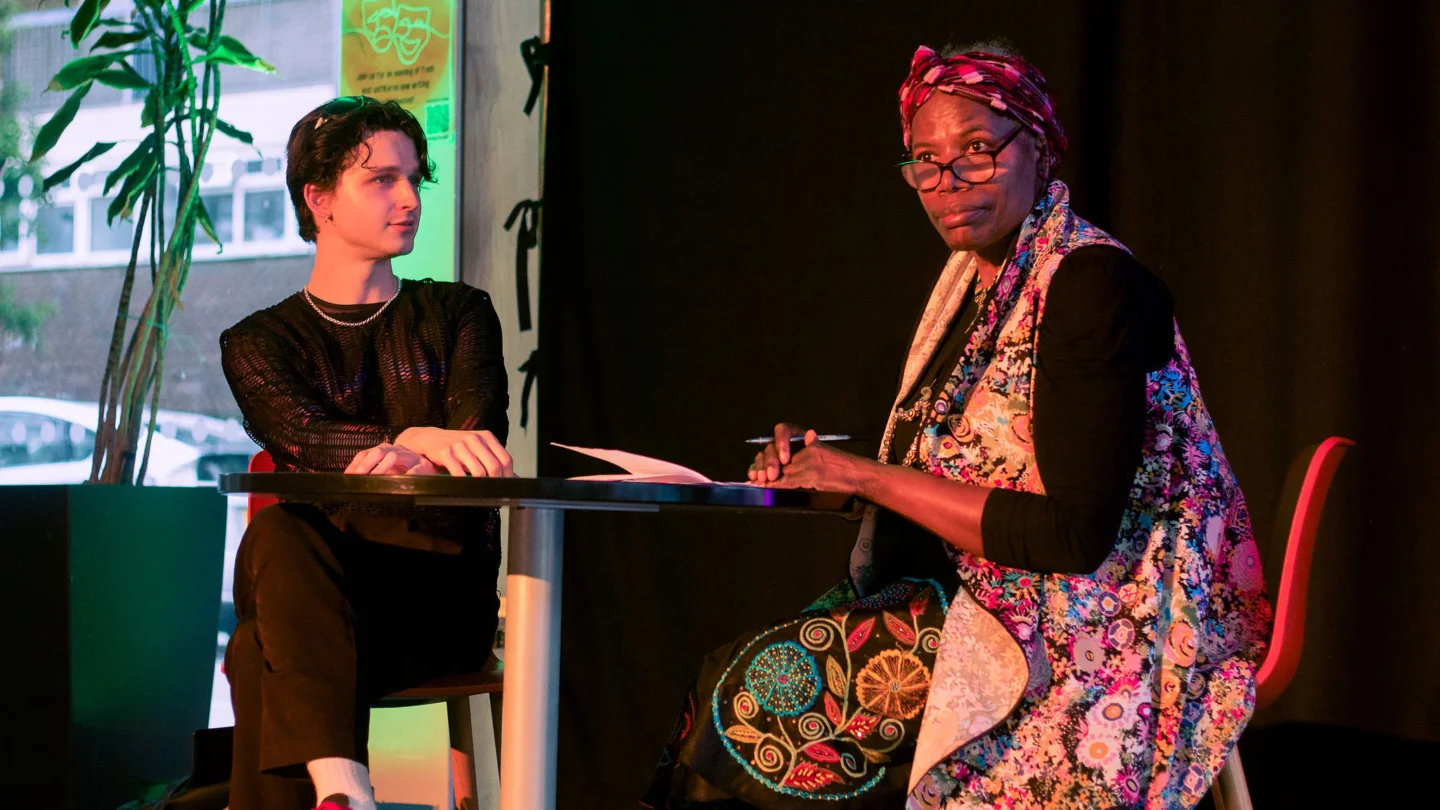 Two people sitting at a table reading