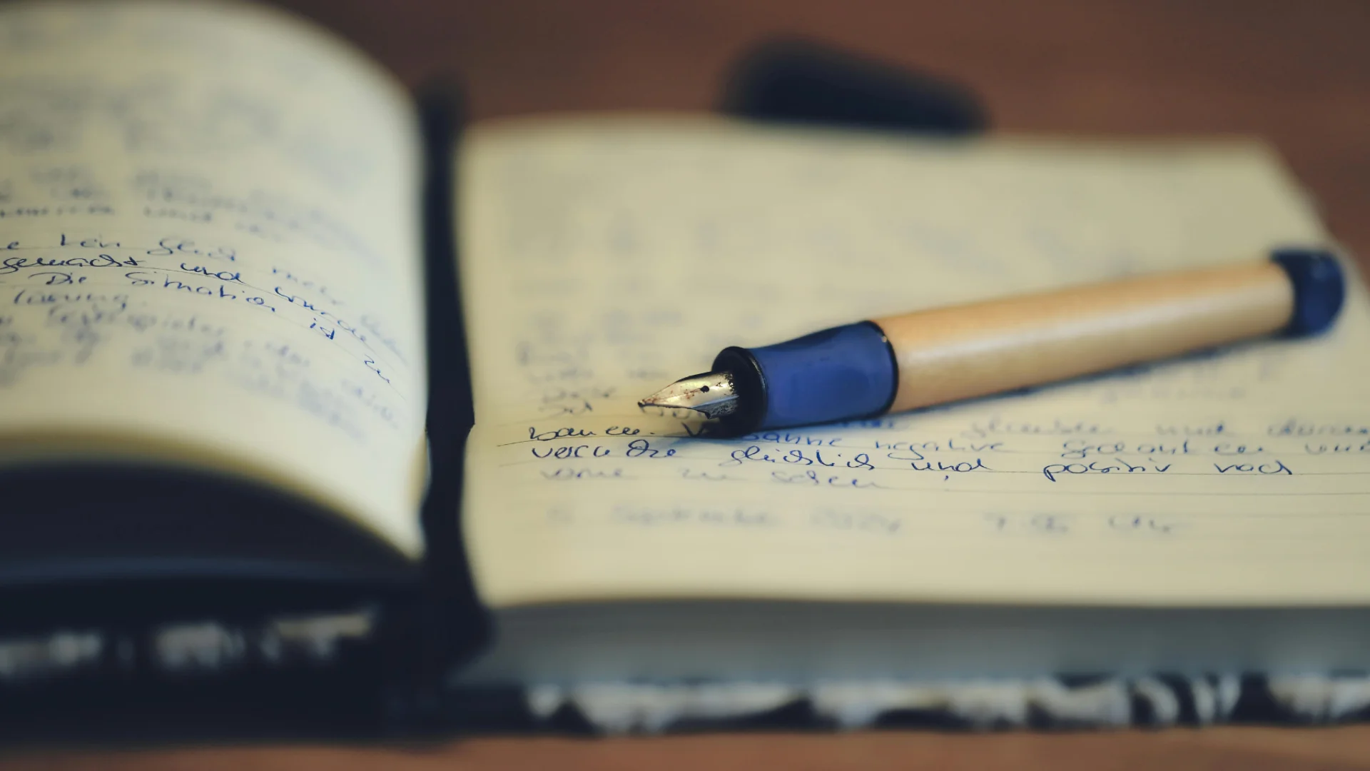 A stock image of a fountain pen resting on a notebook