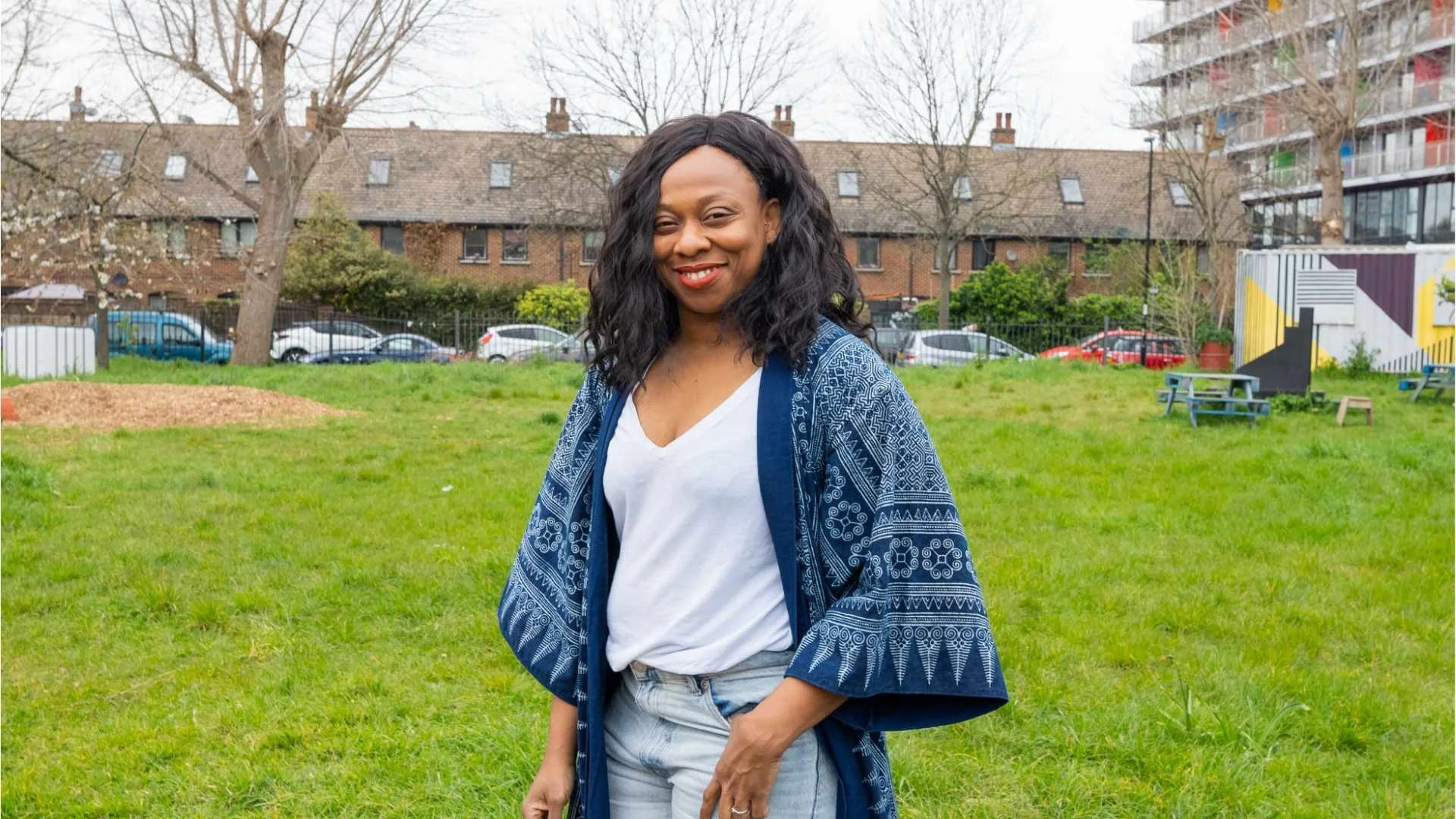 A photo of Vicki Amedume stood in the middle of the Albany garden on a cloudy day.