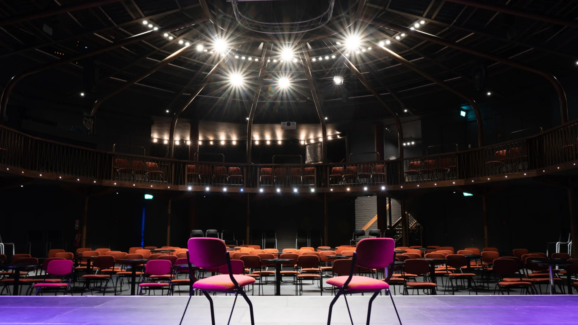 A photograph of the Albany theatre, with two empty chairs facing out towards rows of more empty chairs.