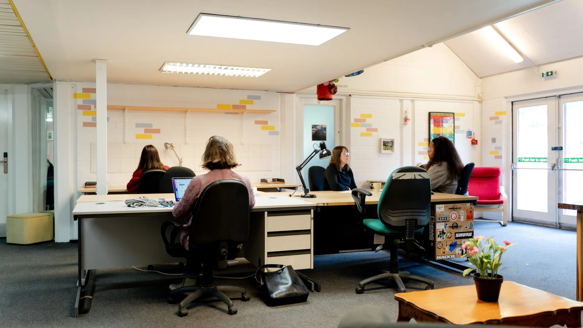 a group of people sitting around a table working