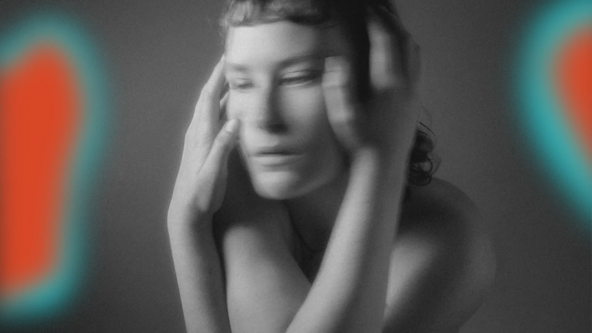 a black and white figure holding their face