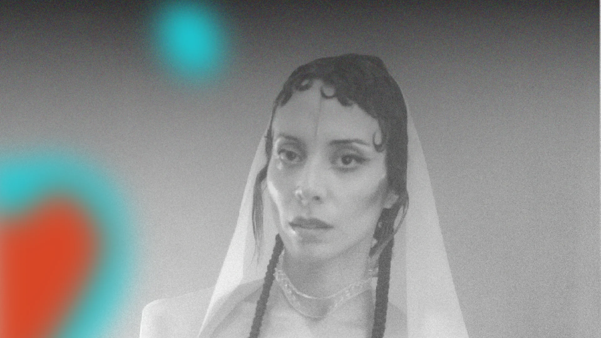 A person in black and white, wrapped in a shroud