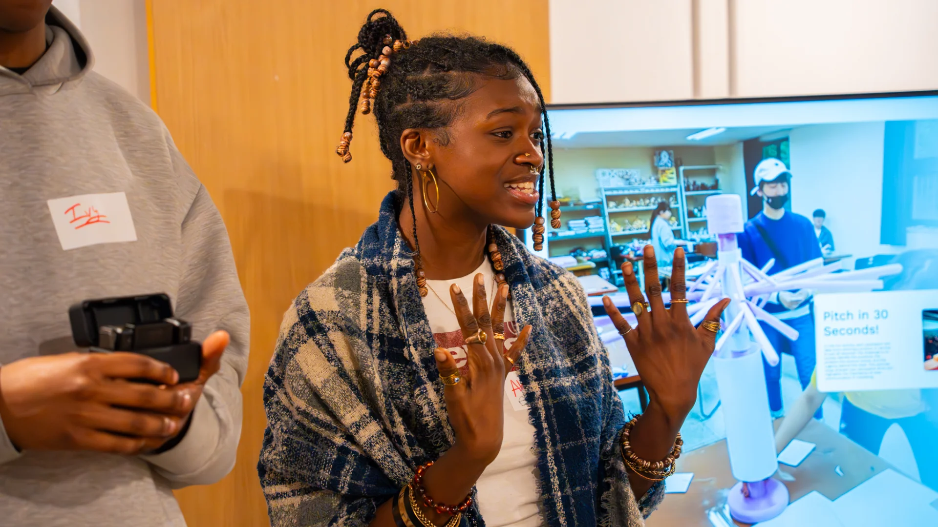 A person talking in front of a screen