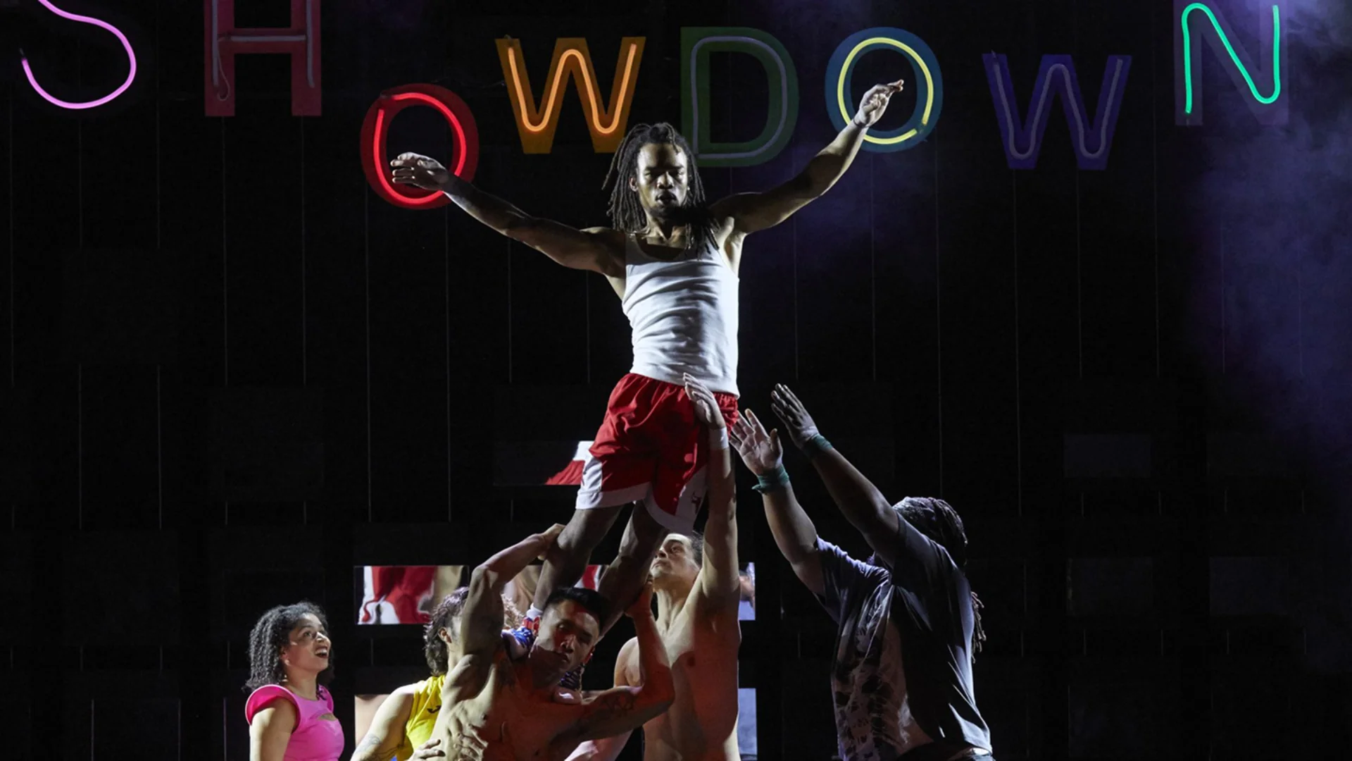 Performer being raised by a group of performers.