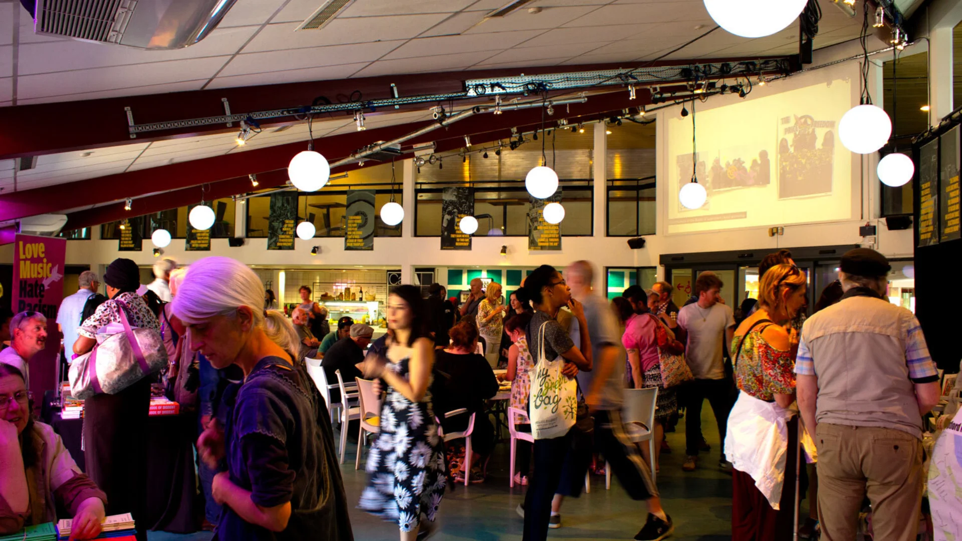 A photo of a group of people standing around during an event in the Albany cafe.
