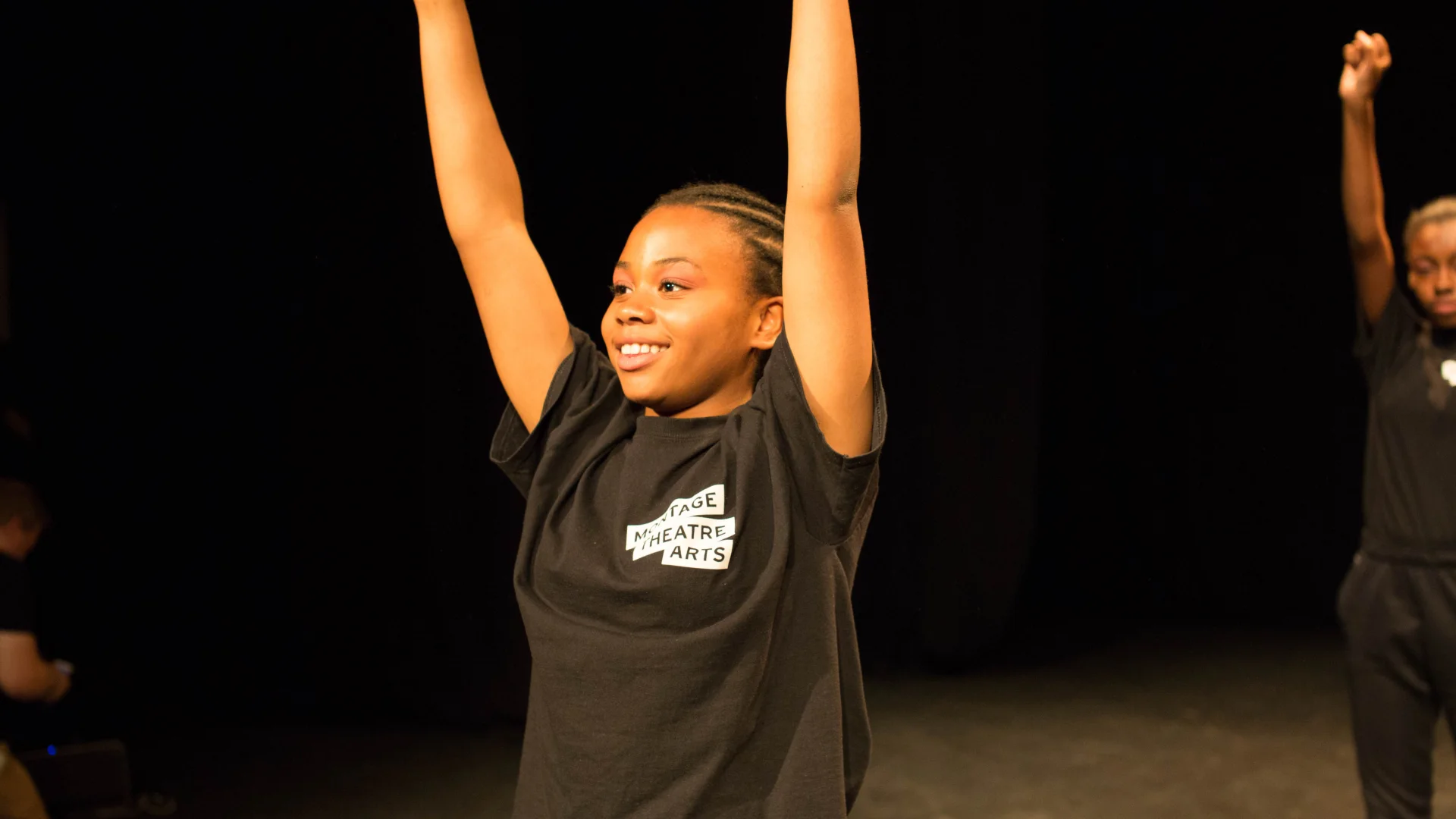 A child with their hands in the air
