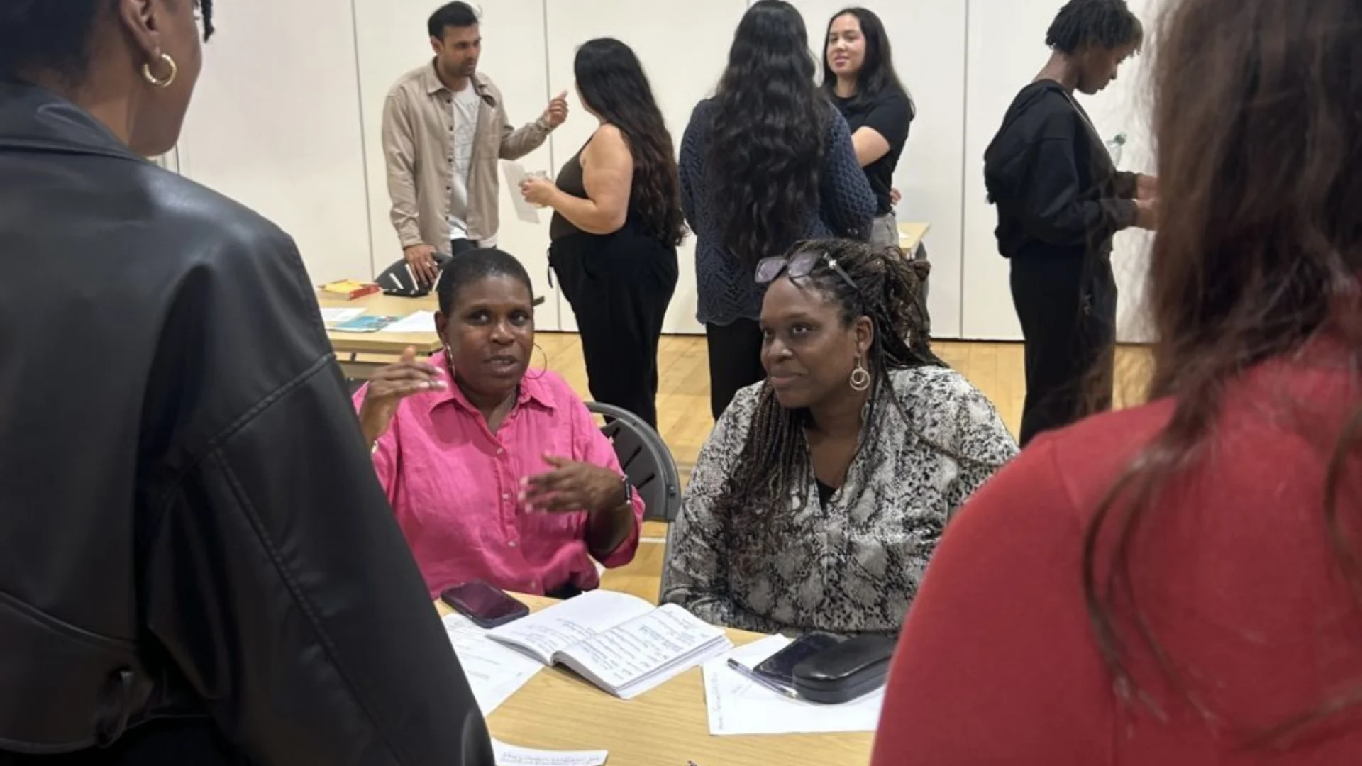 Two people talking to two people behind a table