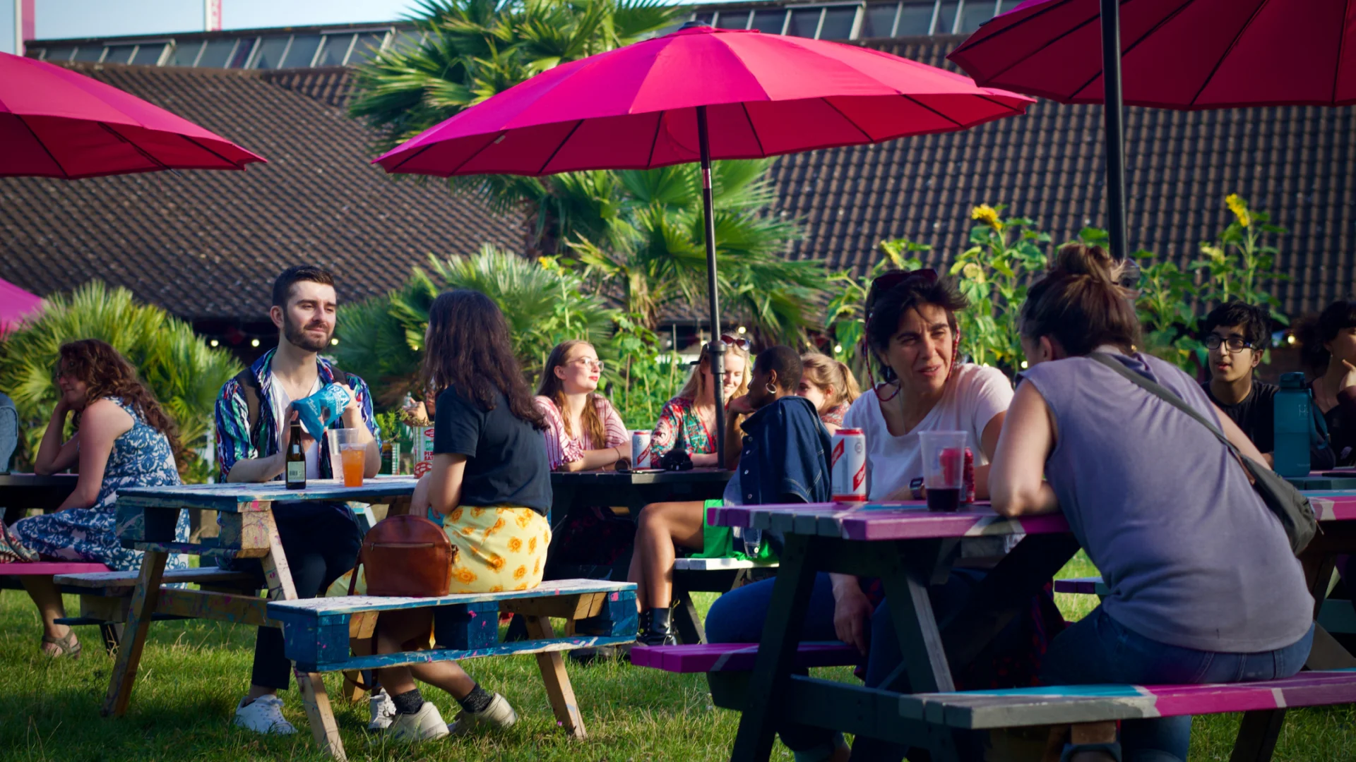 People sitting at picnic tables