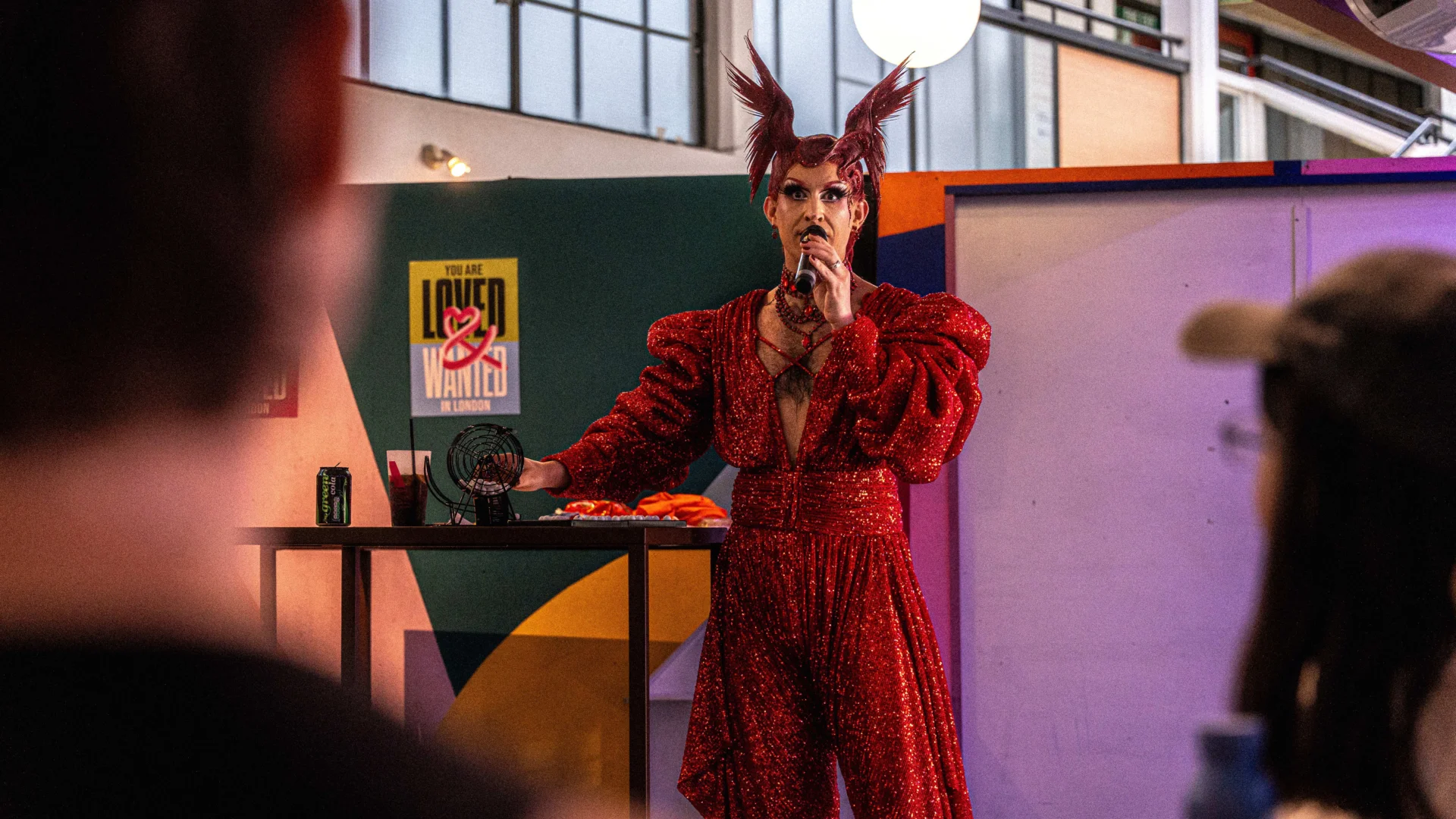 A drag queen talking into a microphone