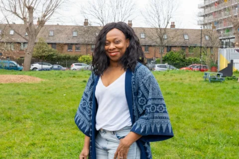 A photo of Vicki Amedume stood in the middle of the Albany garden on a cloudy day.
