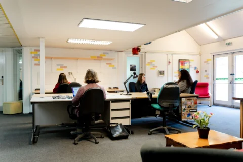 a group of people sitting around a table working