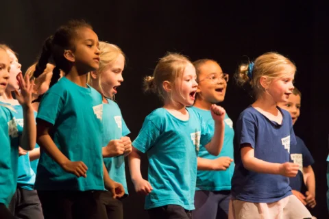 Group of children performing on stage