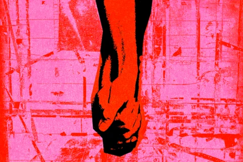 Two hands laced together, treated in red and pink