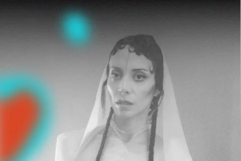 A person in black and white, wrapped in a shroud