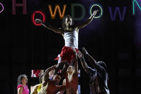 Performer being raised by a group of performers.