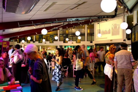 A photo of a group of people standing around during an event in the Albany cafe.