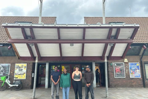 A group of people standing outside the Albany