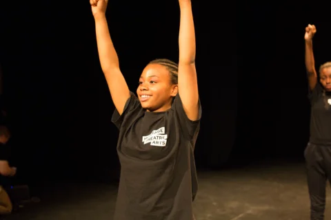 A child with their hands in the air