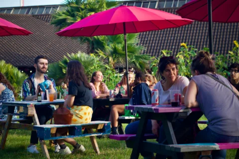 People sitting at picnic tables