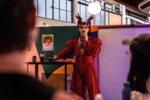 A drag queen talking into a microphone