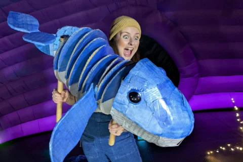 Woman and whale puppet